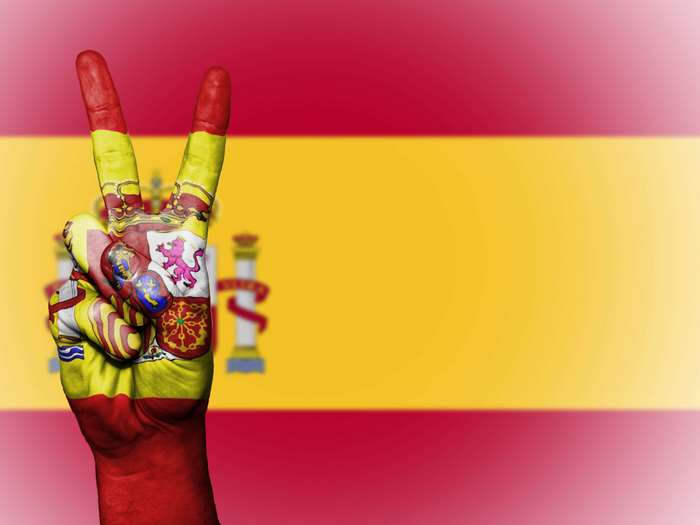 Hand painted with Spanish flag making peace sign