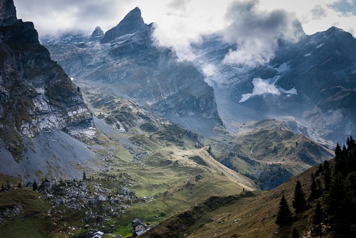 Misty mountain peaks and a valley with houses