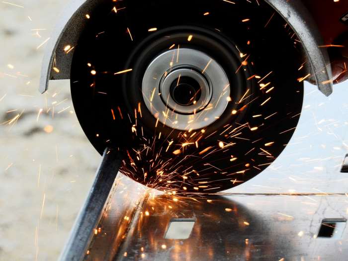 Angle grinder cutting metal with sparks
