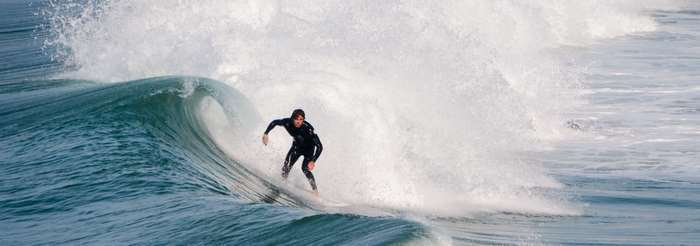 Surfer riding a wave in a wetsuit