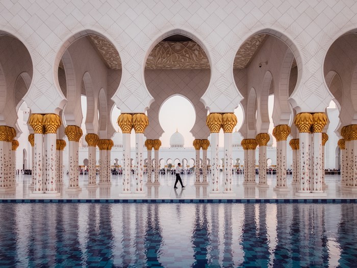 Man walking by pool at Sheikh Zayed Grand Mosque
