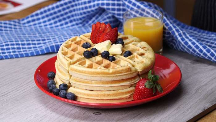 Stack of waffles with strawberries and blueberries