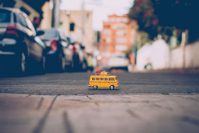 Yellow toy combi taxi on a street