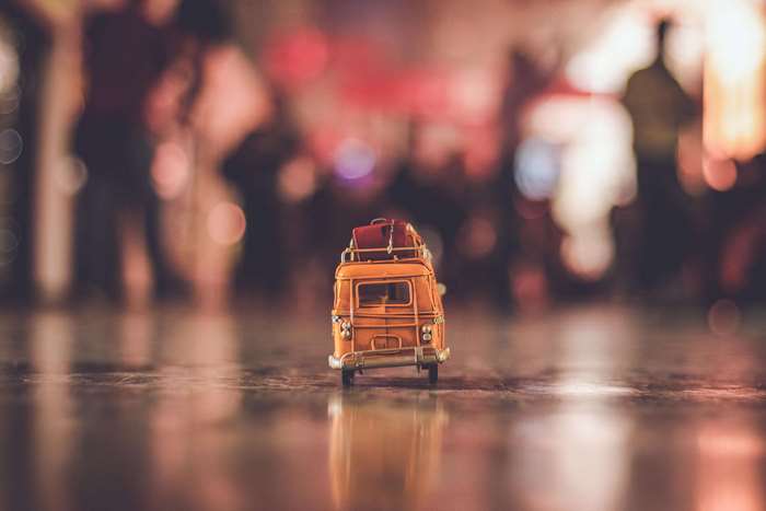 Toy van with luggage on a reflective surface
