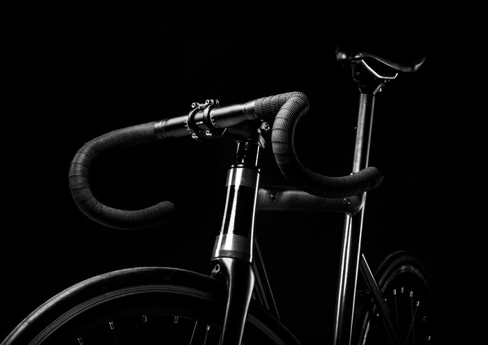 Black and white close-up of a fixie bicycle handlebar