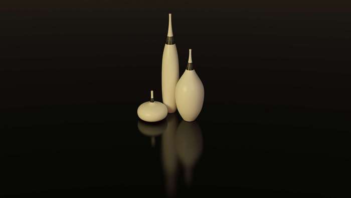 Collection of decorative vases on a reflective black surface