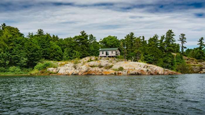 Cabin on a rocky island in a lake