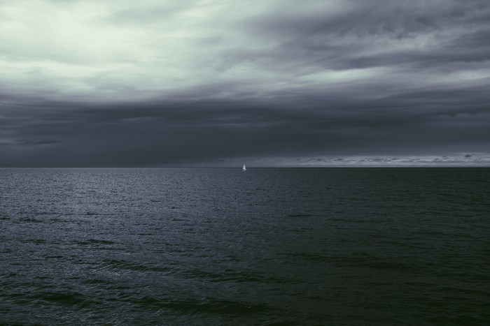 Sailboat on the sea under cloudy sky