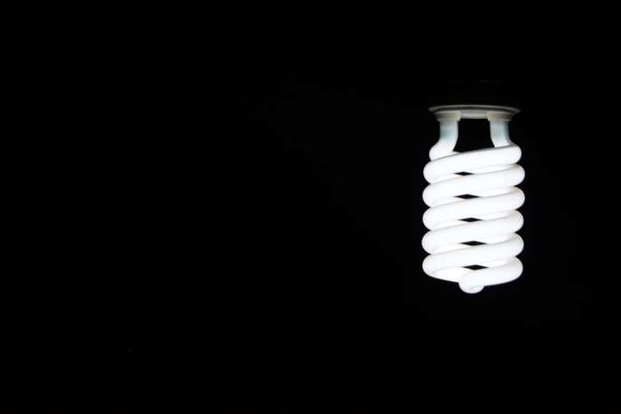 Spiral light bulb on black background