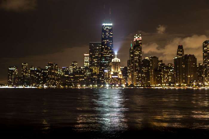 Chicago cityscape at night with water in foreground