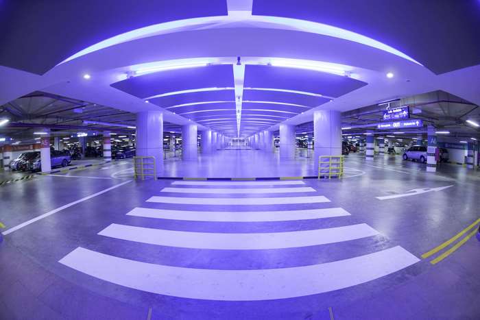 Indoor multi-storey car park with blue lighting
