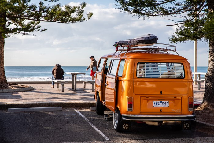 Orange Volkswagen Kombi Van at the Beach