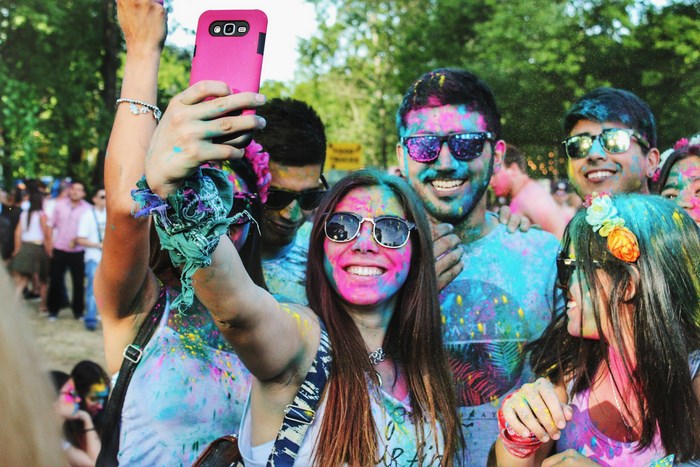 People taking a selfie at a color festival