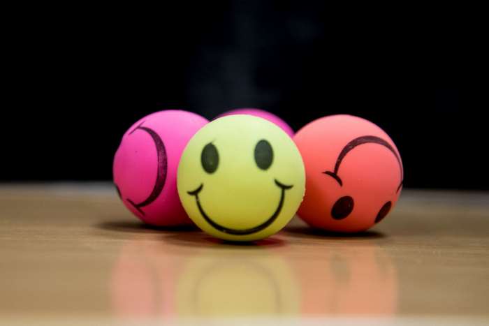 Yellow smiley ball with pink and orange balls