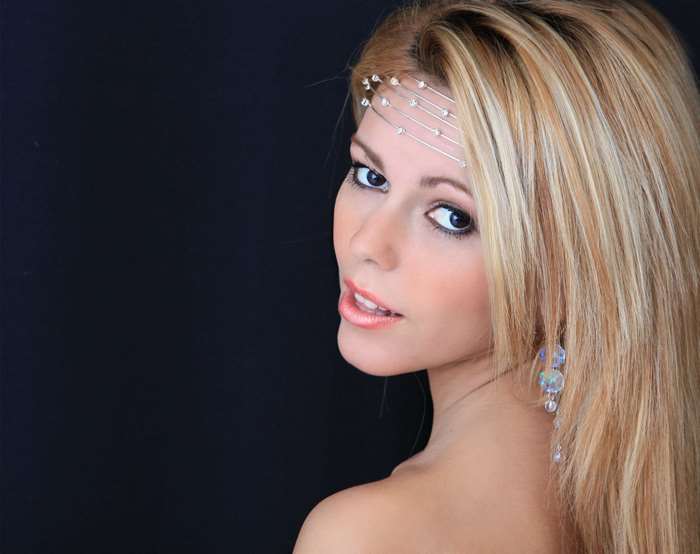 Woman with blonde hair and elegant headpiece