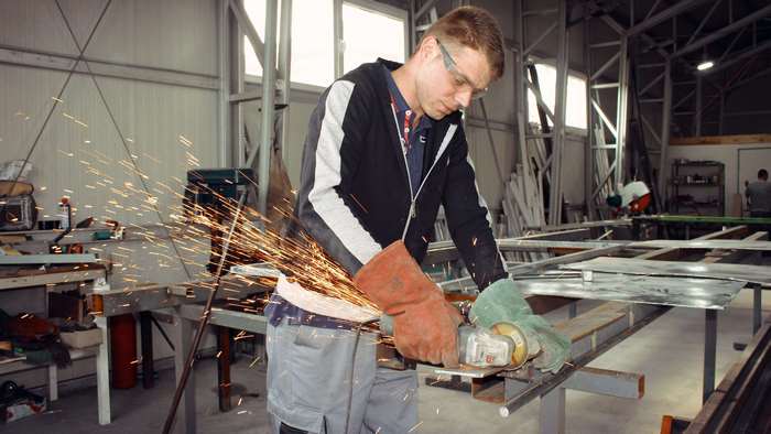 Man using an angle grinder in a workshop