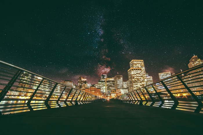 City skyline under the Milky Way galaxy