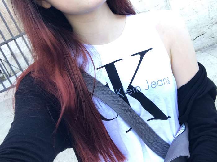 Woman wearing Calvin Klein shirt with red hair