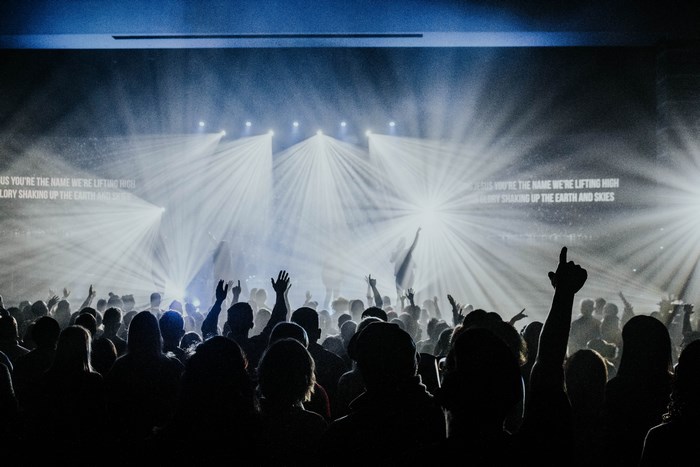 Crowd with hands raised at a worship service