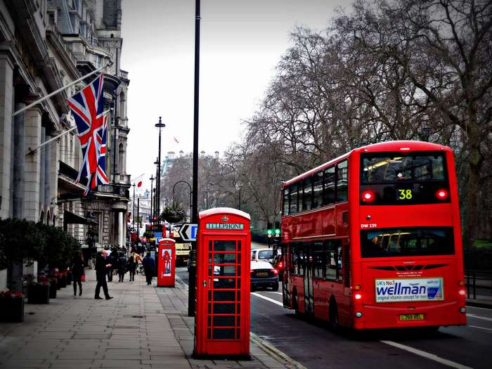 Red double-decker bus and phone booth on a London street