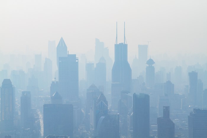 Cityscape shrouded in mist with modern skyscrapers