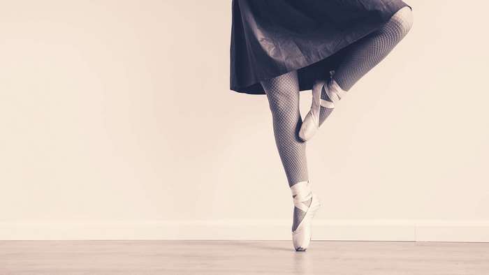 Ballet dancer in pointe shoes and fishnet tights