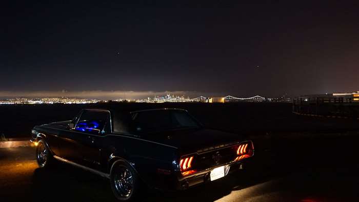 Classic Ford Mustang at Night with City Skyline