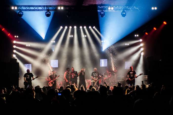 Band performing live concert with audience and stage lights