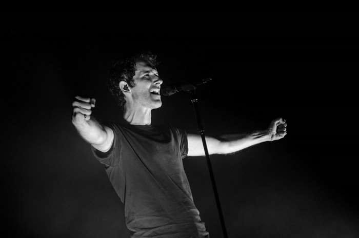 Singer performing on stage with microphone