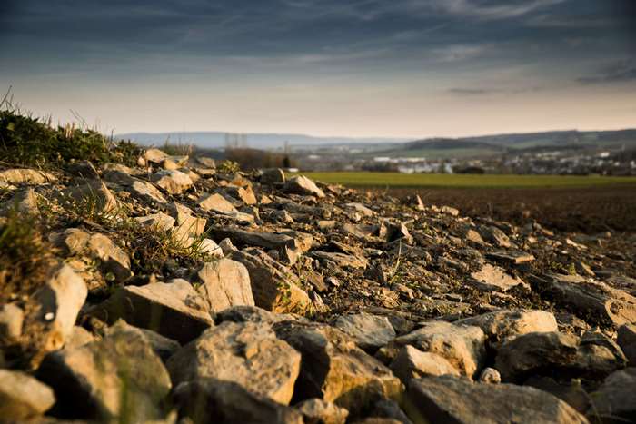 Rocky terrain with a distant town at dusk