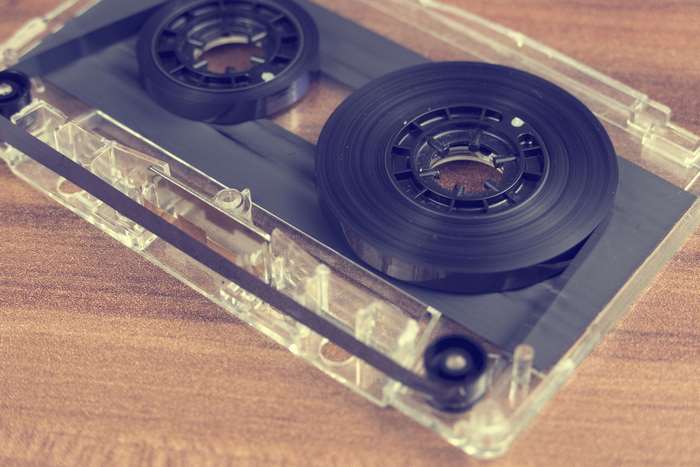 Close-up of an open cassette tape with tape visible