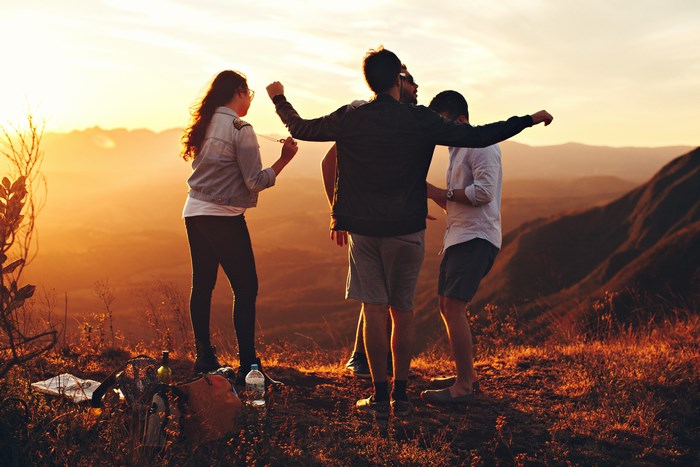 Friends enjoying golden hour on a mountain