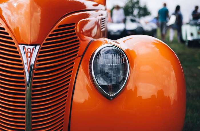 Close up of a vintage orange hot rod car