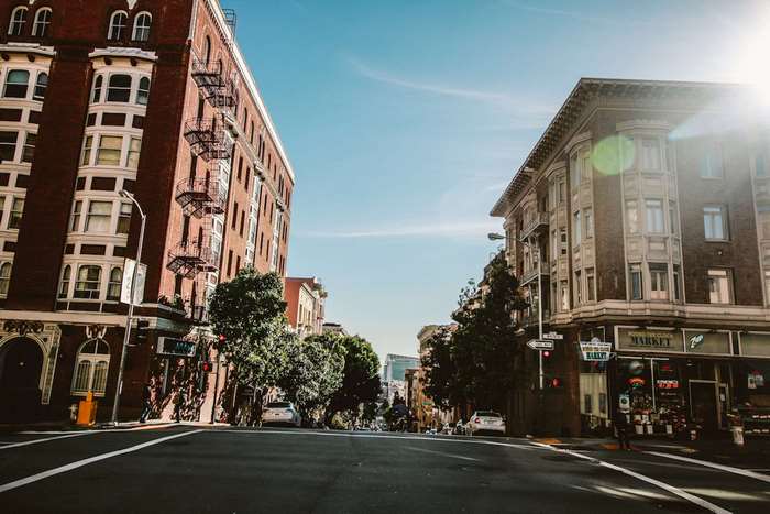 Street view of brick buildings and a market