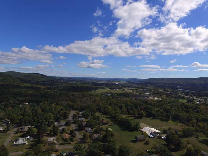 Aerial view of a suburban neighborhood nestled among rolling hills