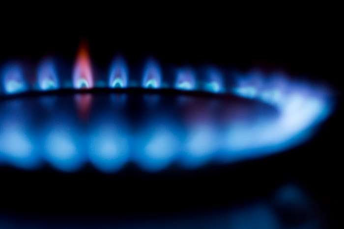 Close-up of blue gas stove burner flames 4K