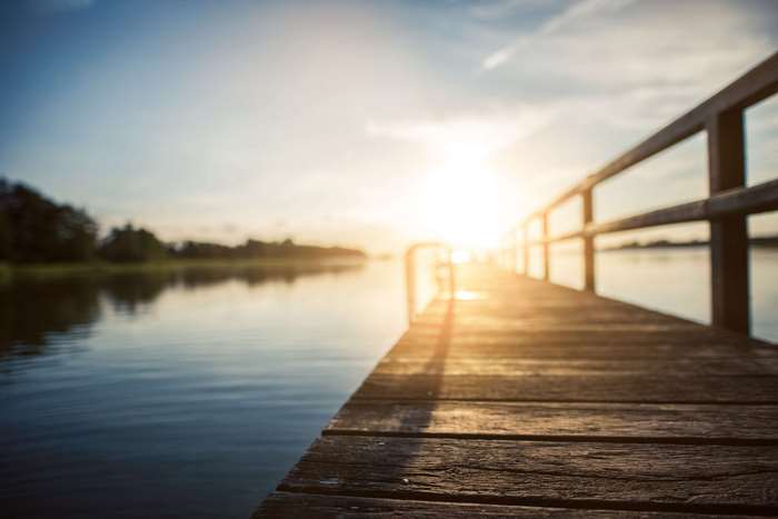Wooden dock on a lake at sunset