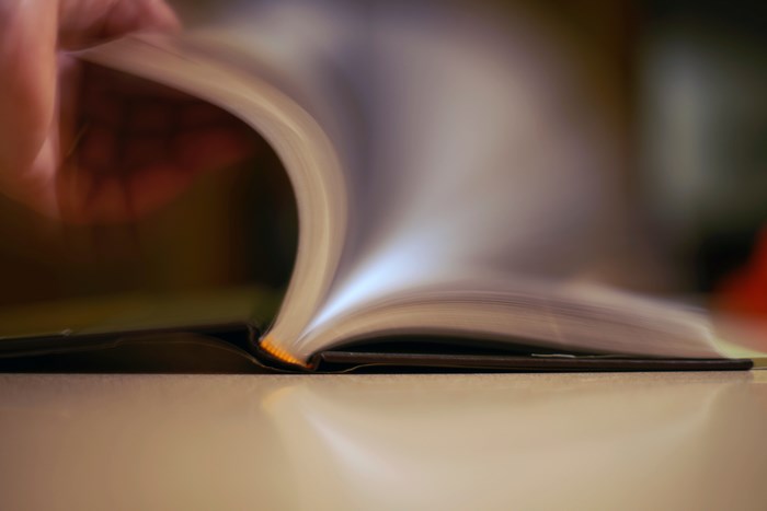 Person flipping pages of a book