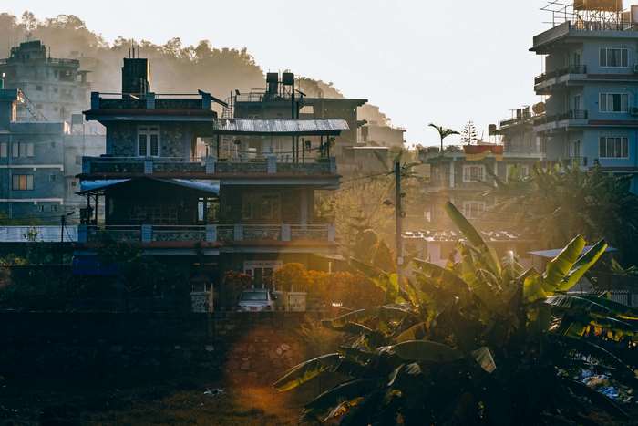 Buildings in a misty mountain town at sunrise