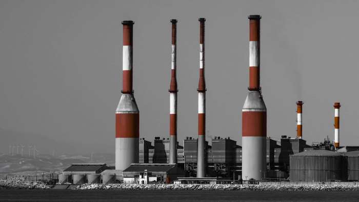 Power plant with red and white chimneys