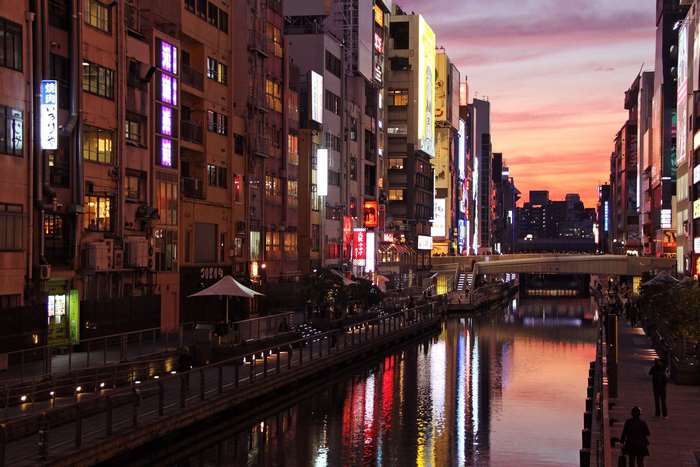 Dotonbori canal in Osaka at sunset with neon lights