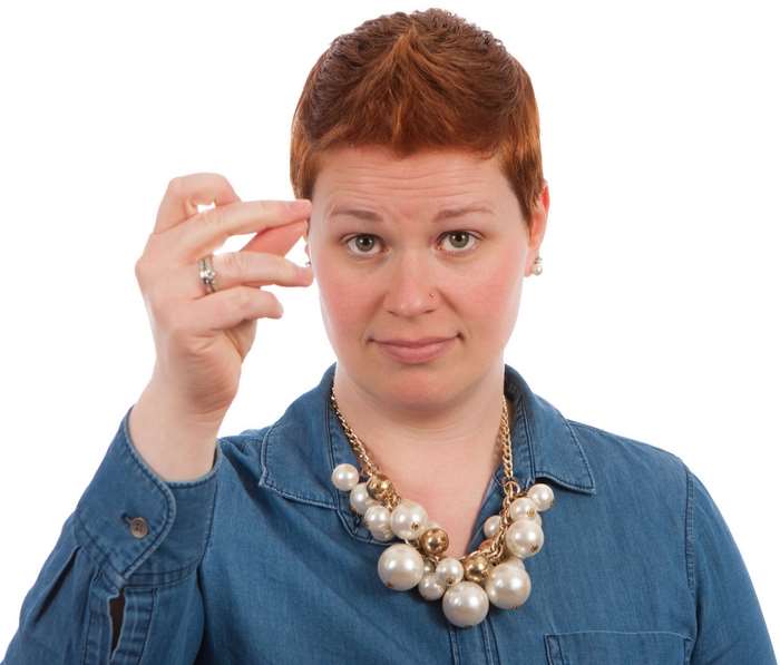 Woman snapping fingers with pearl necklace