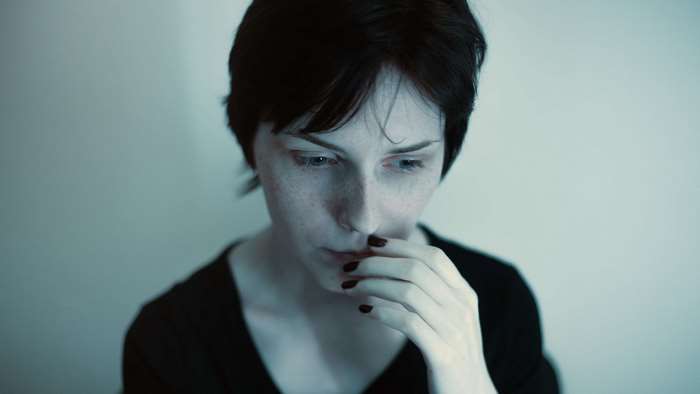 Woman with short black hair and freckles