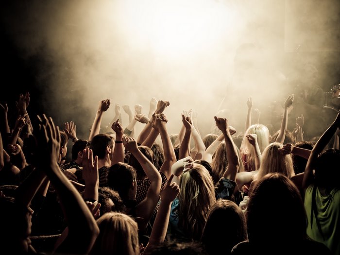 Crowd with hands raised at a concert