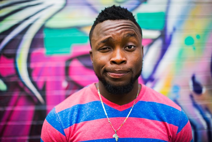 Man with funny face in front of graffiti