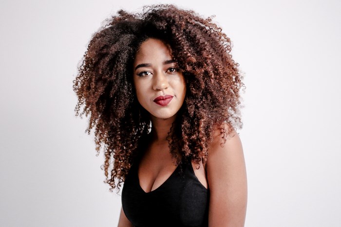 Woman with curly hair and red lipstick