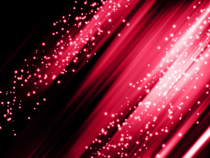 Abstract red light beams with glowing particles on black background