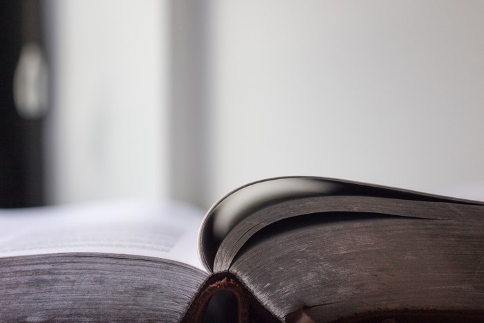 Open old book with dark pages
