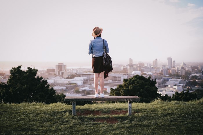 Woman on bench overlooking Auckland city