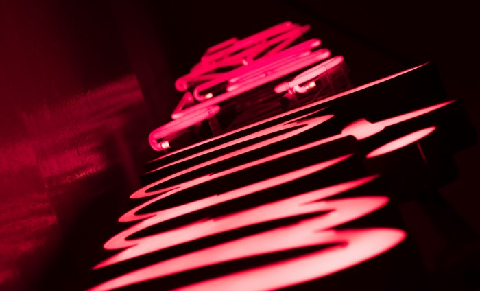 Red neon sign in abstract pattern